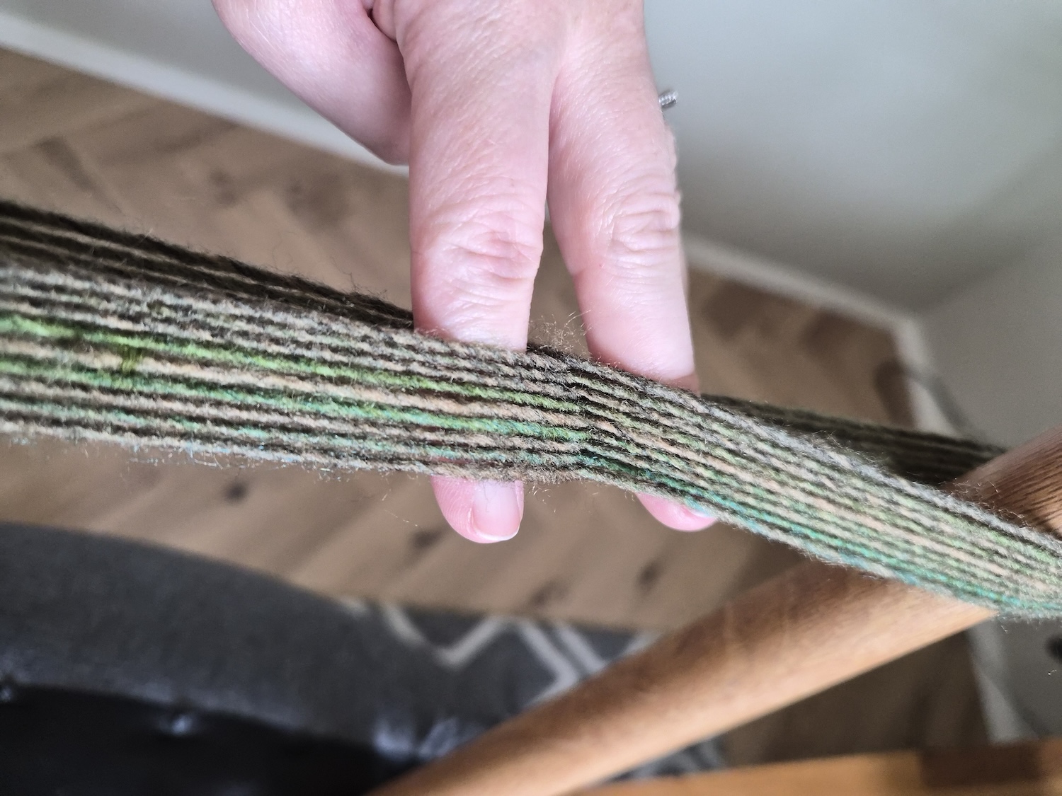 Yarn warped between the legs of two chairs in a figure eight motion, showing the shaft