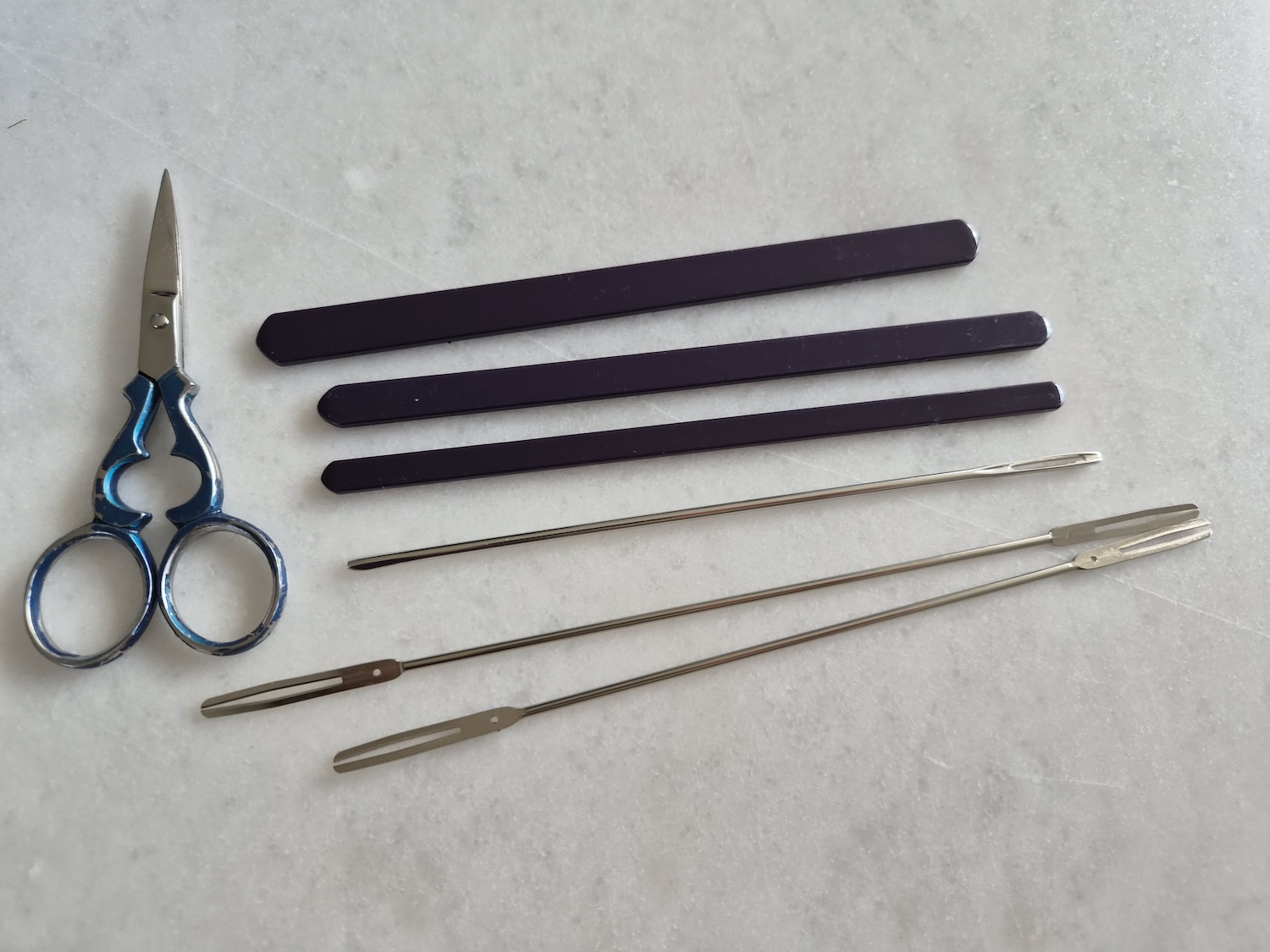 The tools to tie filet lace together with a scissor