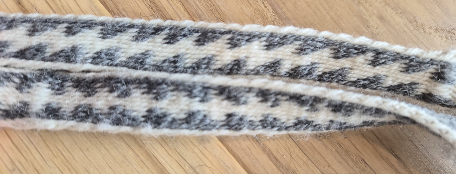 A closeup of the back and front pattern of a tablet woven belt