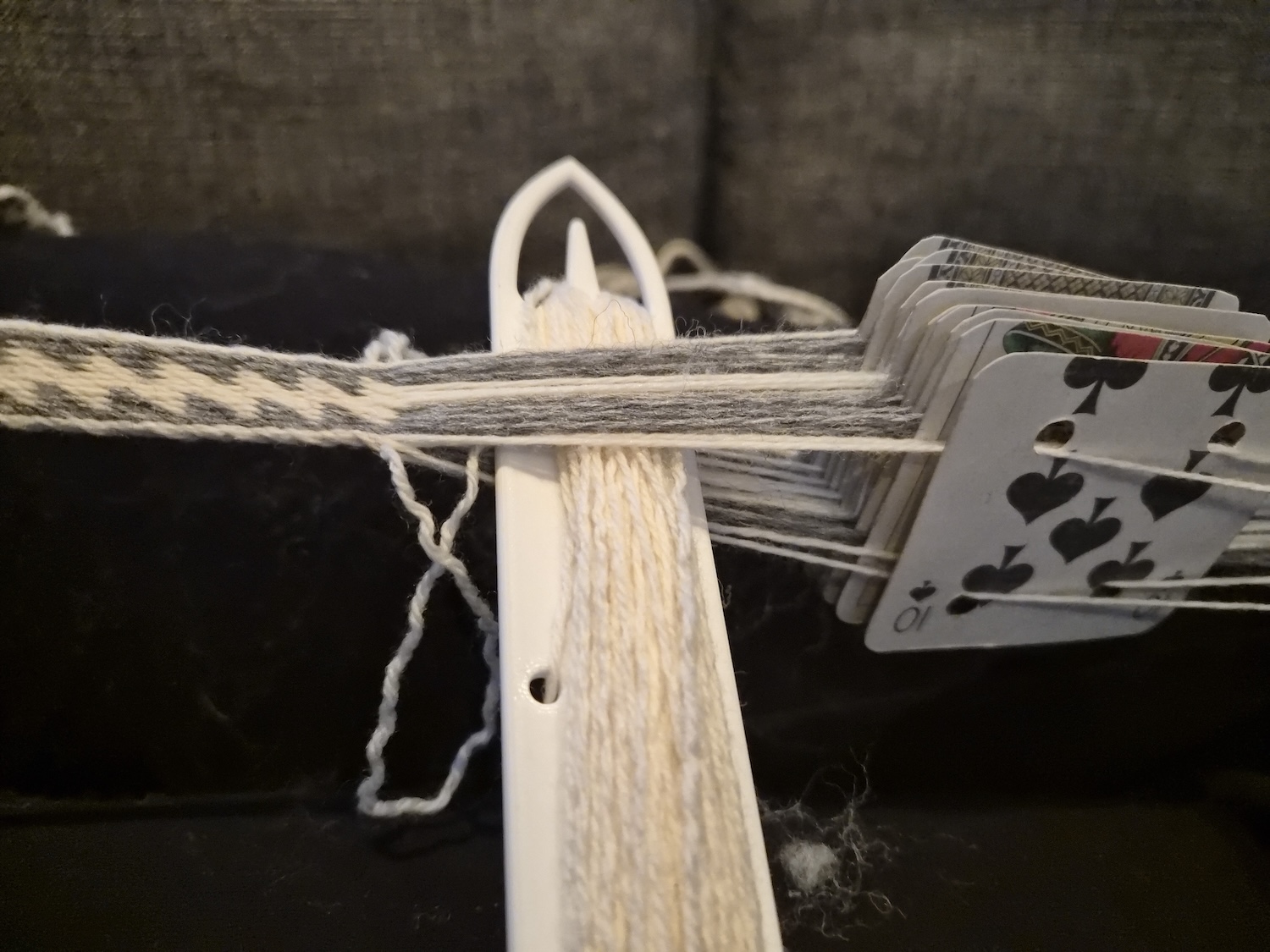 In the middle of moving the shuttle through the shed created by a quarter turn on the tablets in a tablet woven belt