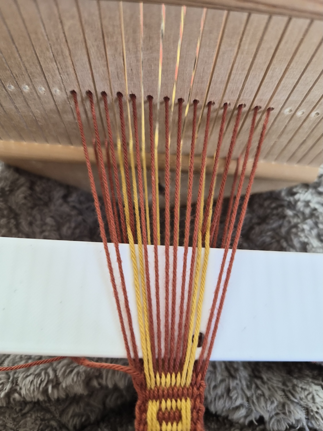 Looking at a simple pickup weave in the middle of picking up the pattern. View from the top.