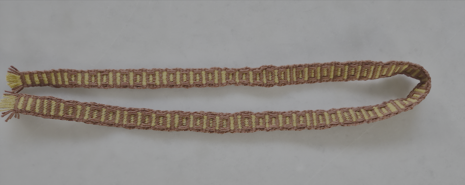 the back of a weft based rep weaved band with pickup pattern in geometric shape