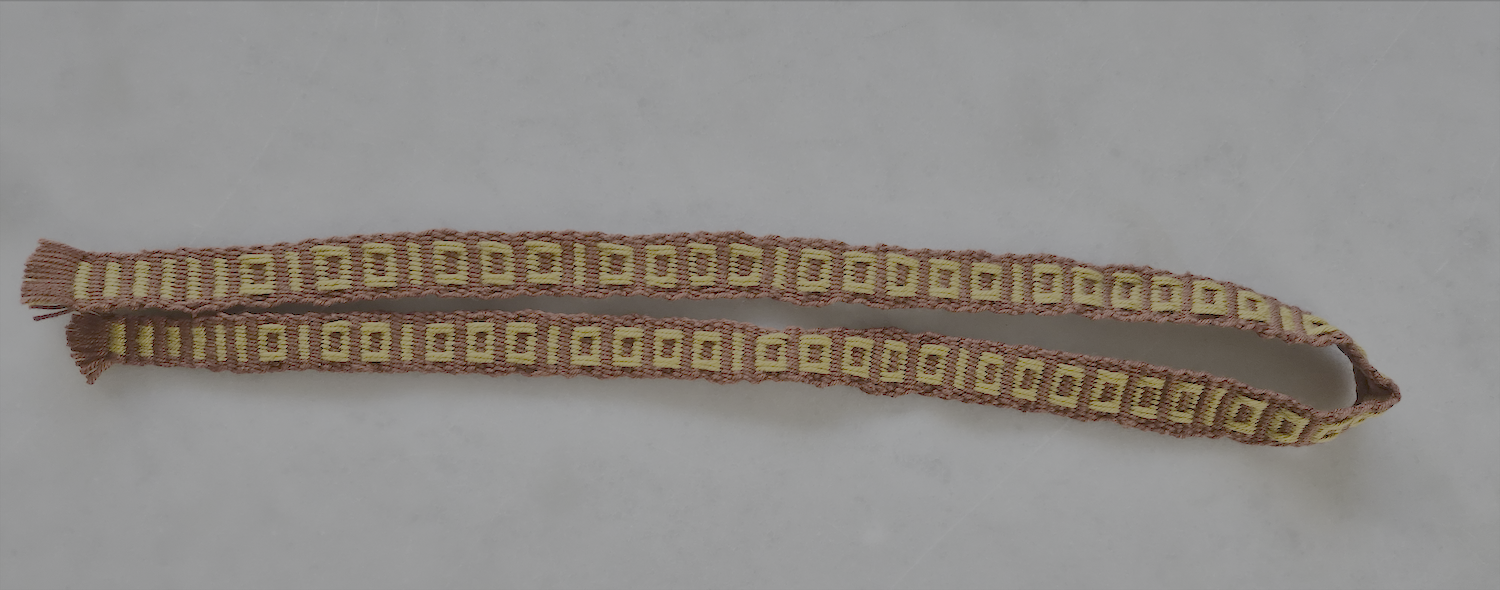 The front of a weft based rep weaved band with pickup pattern in geometric shape