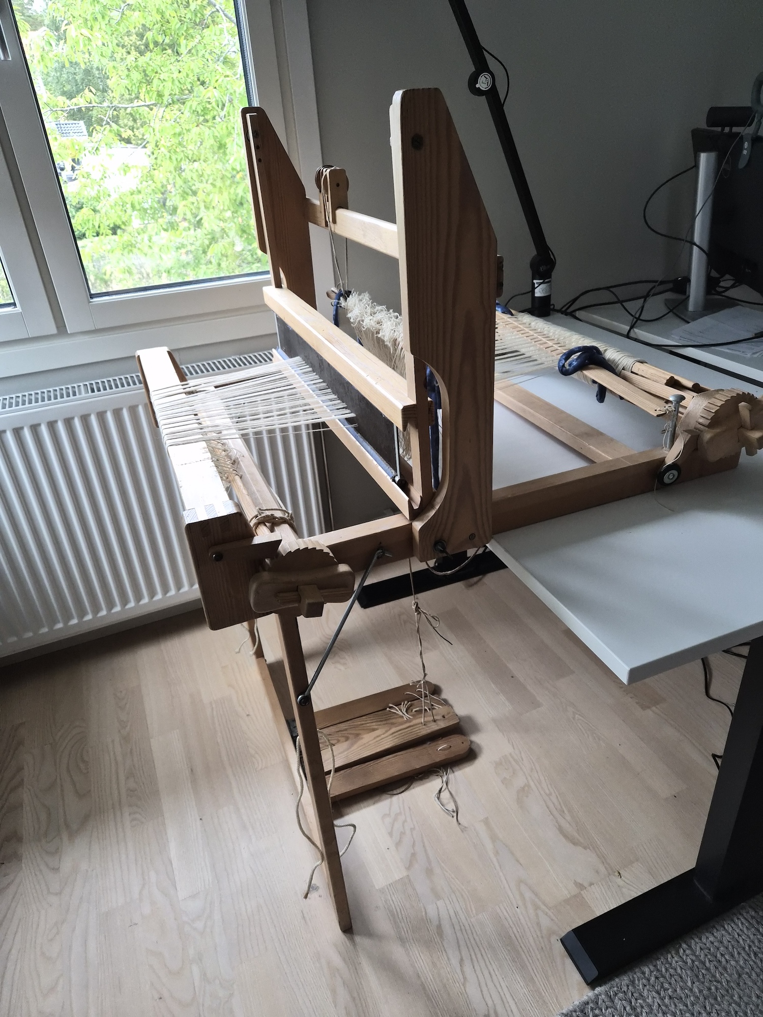A table mounted loom placed on a table