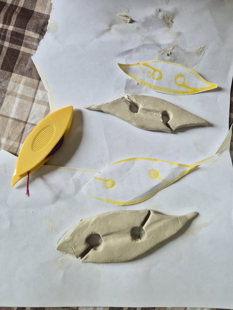 A picture of two tatting shuttles sculpted from clay