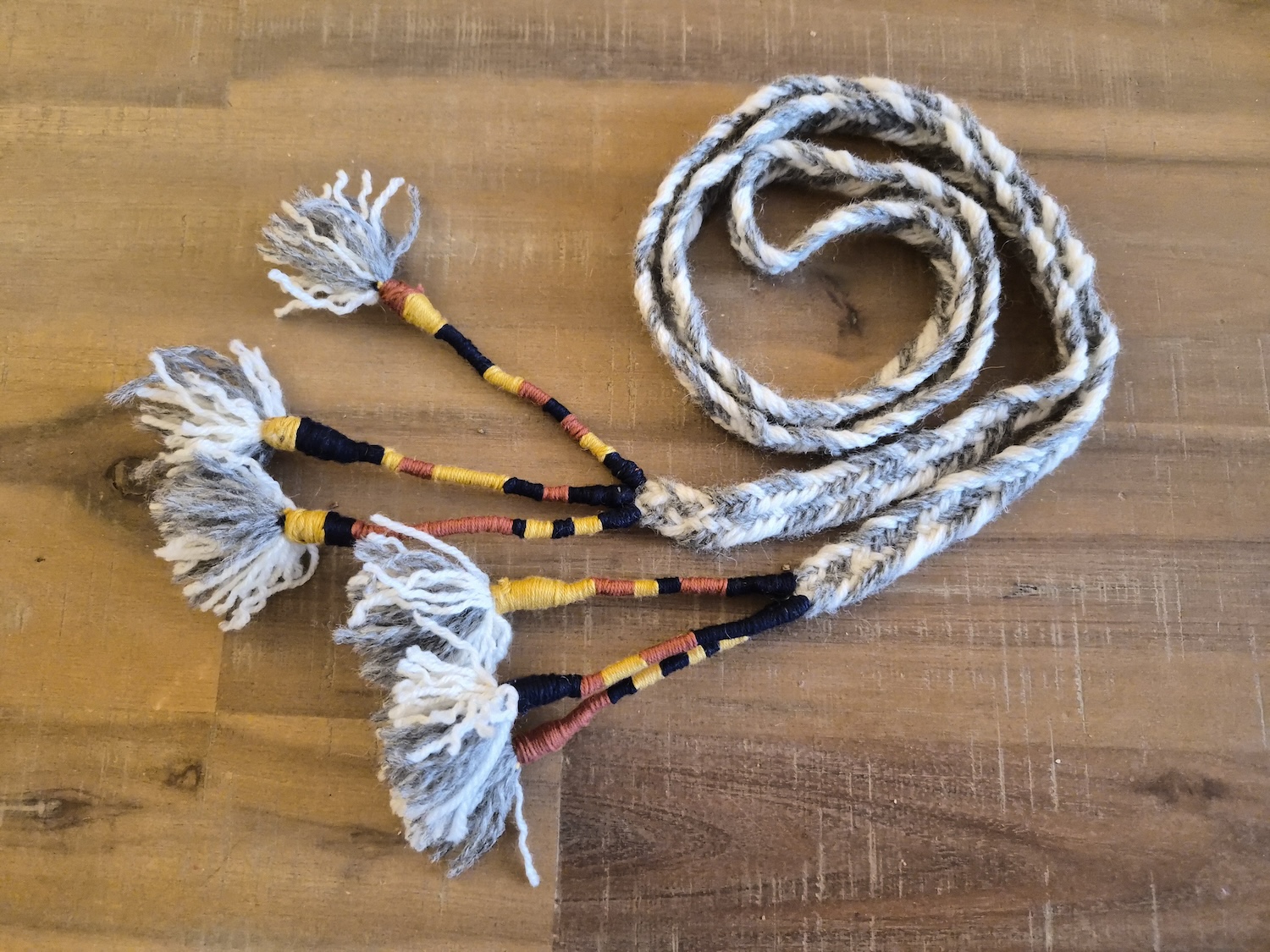 A braided belt following the braid technique and ending from the Skjoldehamn Belt